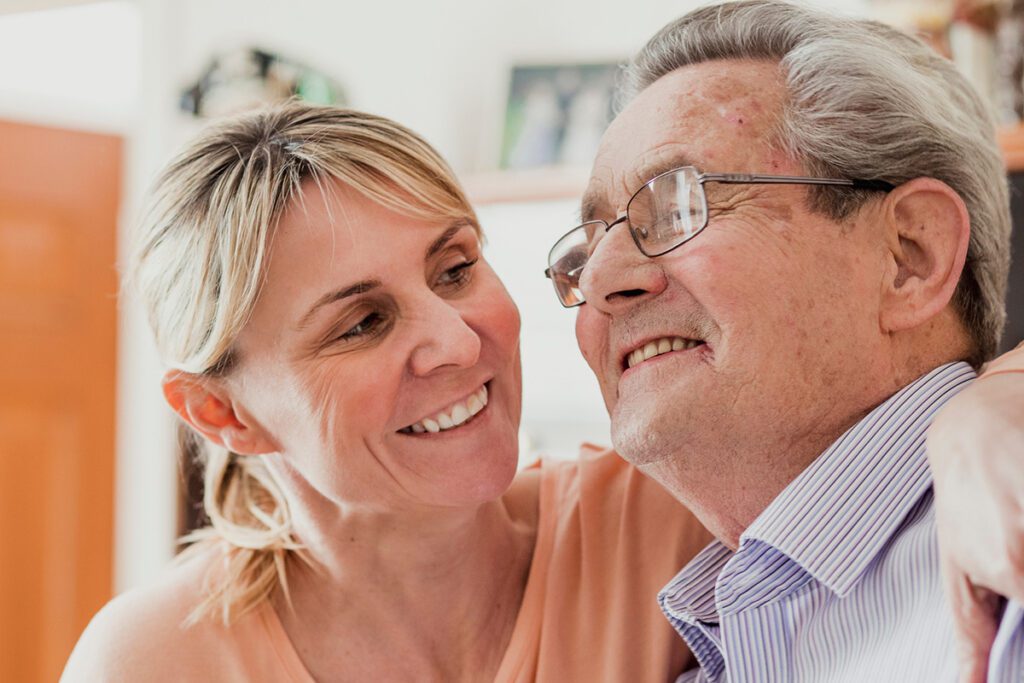 Disability care support worker assisting participant with daily living activities in Brisbane.
